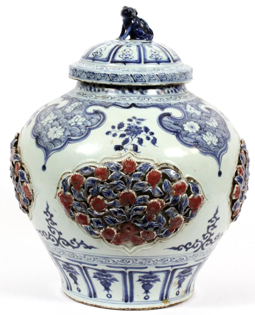 CHINESE BLUE WHITE & RED COVERED JAR: CHINESE BLUE, WHITE, & RED COVERED JAR, H 17'' DIA 14'':A Chinese style painted urn, having a painted lid with a foo form finial. The body has a rotund shape, with pierced and painted rose ornaments i