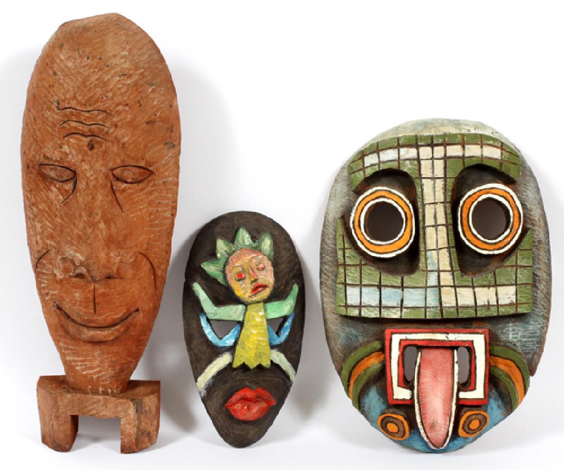 HAITIAN WOOD MASKS 3 ITEMS: HAITIAN WOOD MASKS, 3 ITEMS H 11" - 17", W 7" - 12":Two Haitian masks and one Haitian mask with stand; all made of wood, two are painted. Large mask is signed "J. Findre", H 17'', W 12''. Small mask i
