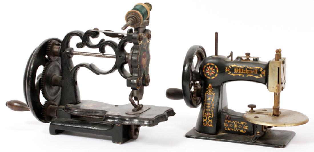 STITCHWELL & OTHER CAST IRON TOY SEWING MACHINES: ANTIQUE STITCHWELL AND OTHER CAST IRON TOY SEWING MACHINES, TWO, H 6"-8":Each made of cast iron with decoration; one by Stitchwell and the other unmarked. Overall measures W.8 3/4"-10".