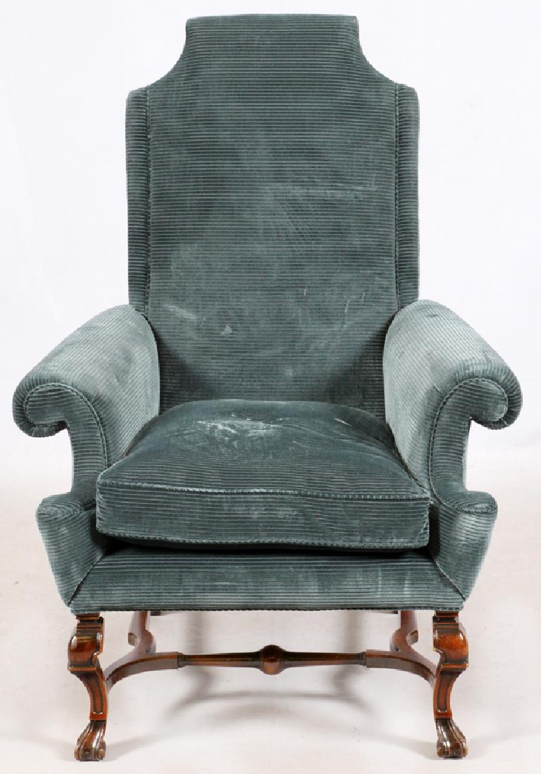 UPHOLSTERED MAHOGANY ARM CHAIR: UPHOLSTERED MAHOGANY ARM CHAIR, H 47", L 36":Tudor style. Upholstered in blue corduroy material, raised over feet joined by a stretcher frame.