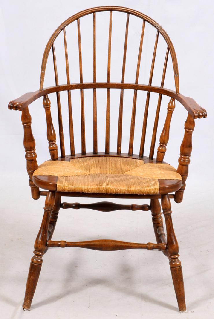 MODERN SACK-BACK WINDSOR CHAIR: MODERN SACK-BACK WINDSOR CHAIR, 20TH C., H 37", W 26", D 18" HAVING CARVED KNUCKLE HANDHOLDS AND A RUSH SEAT, RAISED ON TURNED LEGS JOINED BY STRETCHERS.