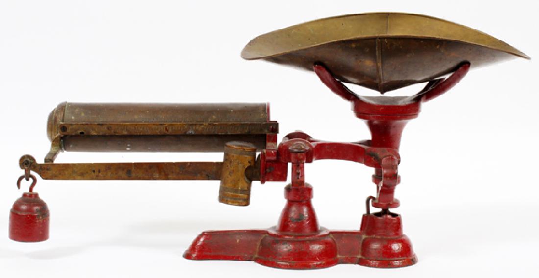 CAST IRON AND BRASS BALANCE SCALE: CAST IRON AND BRASS BALANCE SCALE, H 10 1/2", W 23" HAVING A RED PAINTED CAST IRON BASE AND COUNTER WEIGHT WITH BRASS LEVER, SLIDING COUNTER WEIGHT, PAN AND CYLINDER METER.