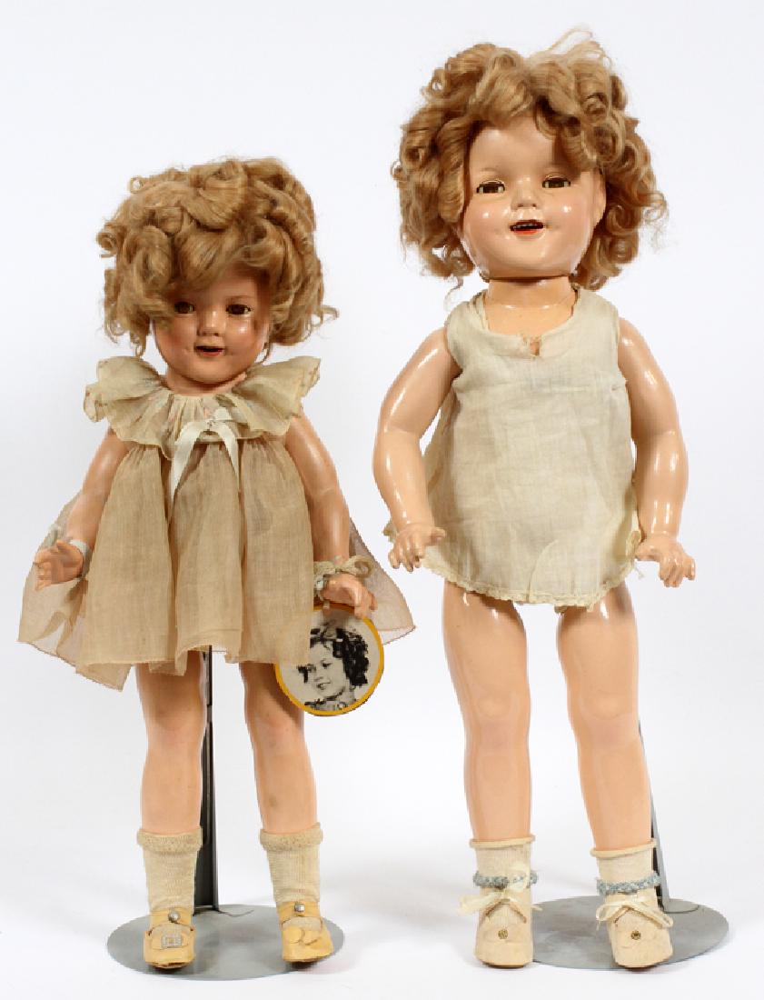 SHIRLEY TEMPLE DOLLS, 2 ITEMS, H 19'' - 22'': SHIRLEY TEMPLE DOLLS, 2 ITEMS, H 19'' - 22''TWO SHIRLEY TEMPLE DOLLS, BOTH MOUNTED ON STANDS. HAVING A COMPOSITION BODY WITH JOINTED SHOULDERS, LEGS AND HEAD, THE FACE FEATURES SLEEPY EYES. ONE HAVING