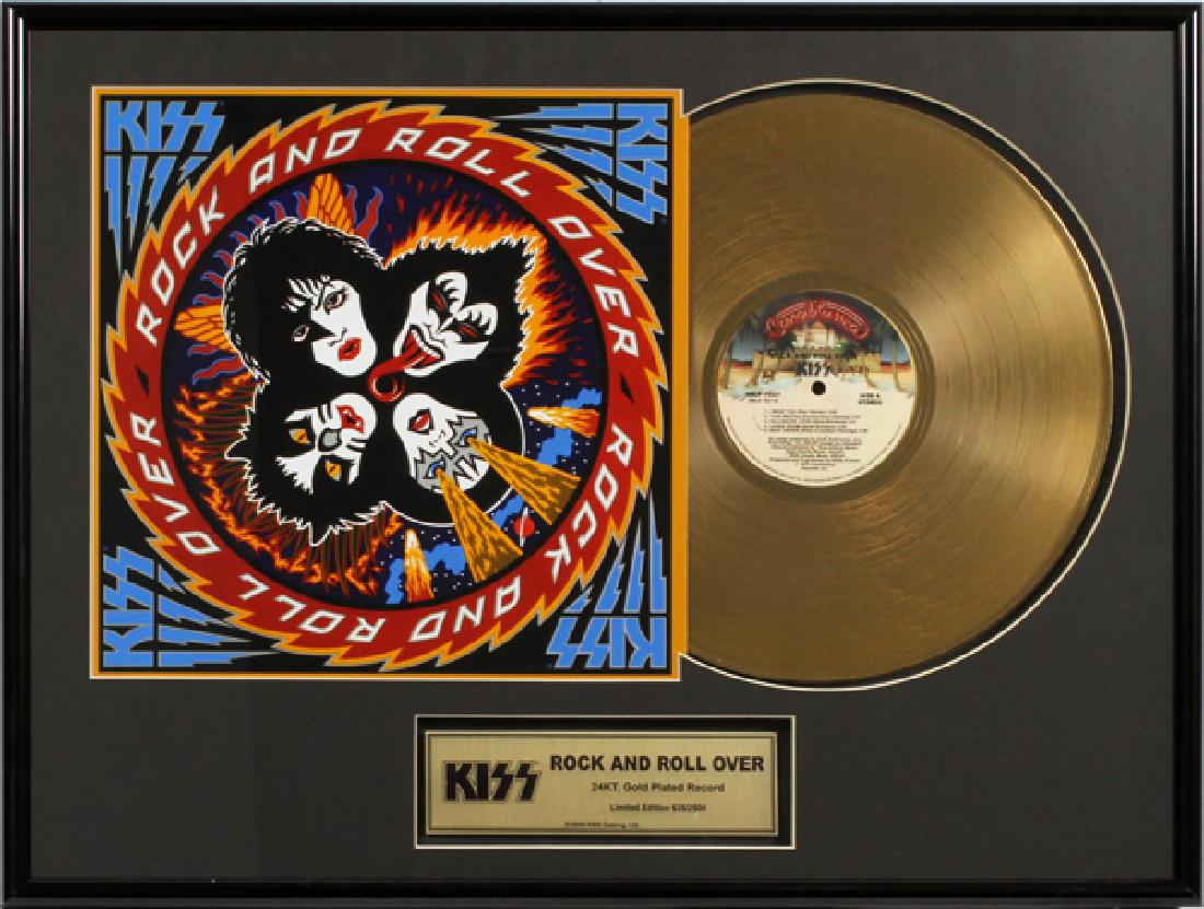 KISS, 'ROCK & ROLL OVER' 24KT GOLD PLATED RECORD: KISS, 'ROCK & ROLL OVER' 24KT GOLD PLATED RECORD, C. 2009, H 15'', W 21'', 635/2500 INCLUDES A RECORD ALBUM COVER TITLED: "ROCK AND ROLL OVER" WITH A 24KT GOLD PLATED RECORD. ALSO INCLUDES A CERTIFICA