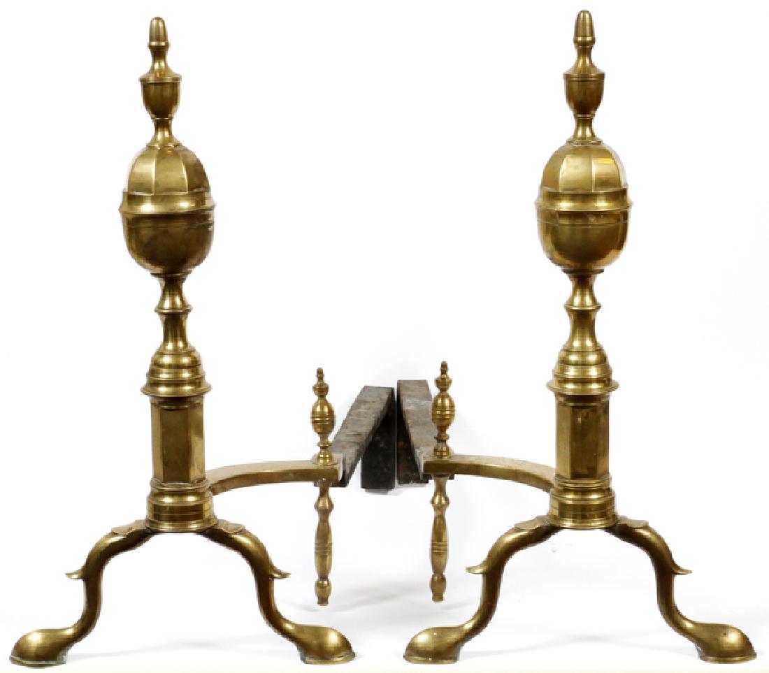 ANDIRONS, PAIR. H 24 1/2'', L 23 1/2'': ANDIRONS, PAIR. H 24 1/2'', L 23 1/2''TURNED SPINDLE DESIGN OF BRASS CONTOURED LEGS WITH HOOFED FEET.