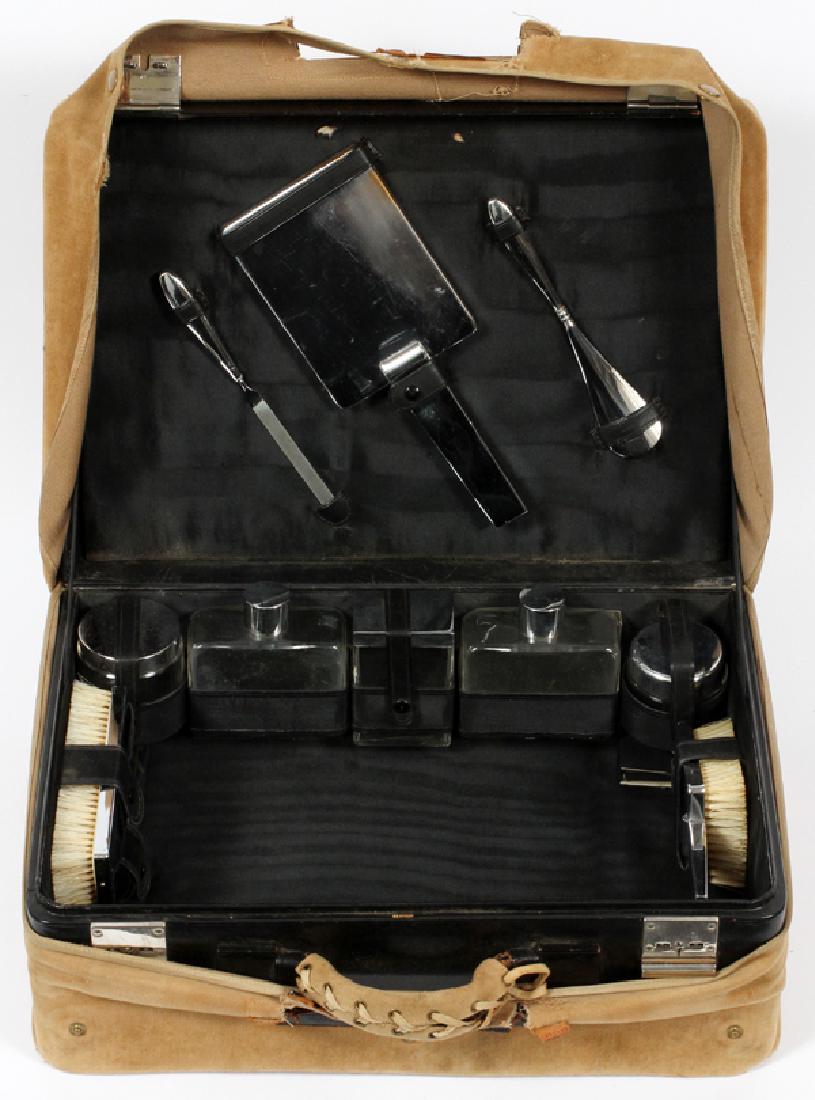 LEATHER CASED, TRAVEL VANITY SET, C1950, 12 PCS.: LEATHER CASED, TRAVEL VANITY SET, C1950, 12 PCS., H 12", W 16", D 6" (CASE)LEATHER CASED TRAVEL VANITY SET OF PLATED OVER COPPER PIECES INCLUDING: HAND MIRROR, 10" L., FIVE CREAM AND PERFUME JARS AND