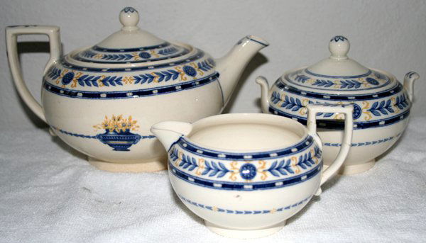 WEDGWOOD ETRURIA PORCELAIN TEA SET: WEDGWOOD ETRURIA TEA SET PORCELAIN TEA SET WITH BLUE BORDER, 3 PCS., H 3"-5", W 5"-8 1/4":Including one tea pot, creamer and covered sugar bowl. Each consisting of a white ground with blue leaf and fl