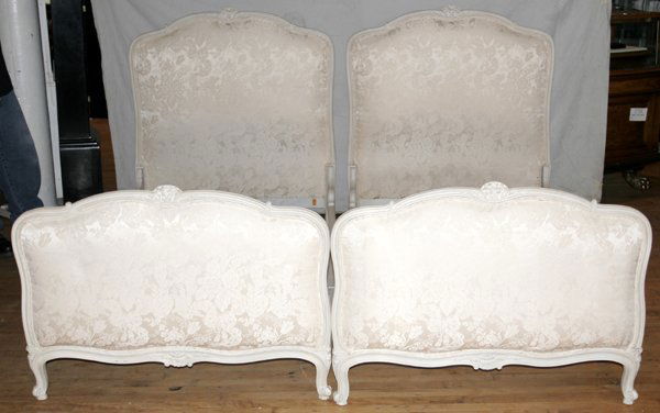 L. ALABOINE FRENCH ANTIQUED FINISH TWIN BEDS: L. ALABOINE & CO., N.Y. & PARIS, FRENCH ANTIQUED FINISH TWIN BEDS, C.1920, PAIR, W 38", L 76":Each head & foot board, having antiqued white wood frames, centered by white silk upholstery. Label to int