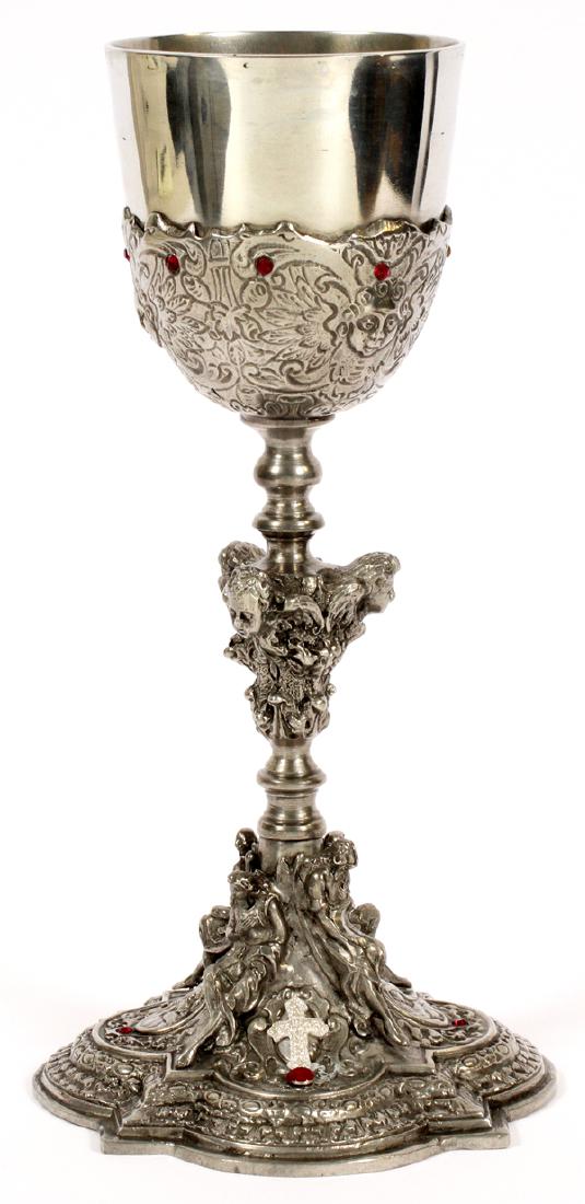 PEWTER CHALICE WITH SILK LINED CASE: PEWTER CHALICE, WITH SILK LINED CASE, 20TH C, H 10" PEWTER CHALICE WITH RED FACETED STONE ACCENTS AND MASKS ON THE STEM AND FIGURES AT THE BASE. HAVING A SILK LINED CASE. MARKED 'PEWTER' ON THE UNDERS