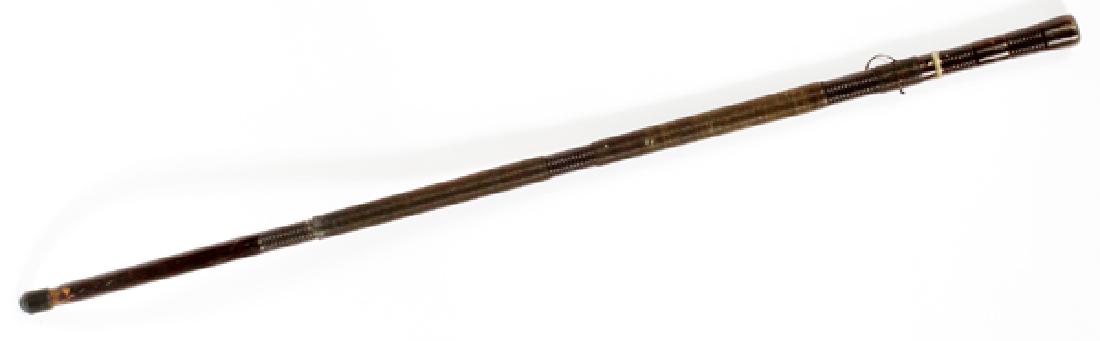 JAPANESE SWORD CANE, C. 1920, L 36": JAPANESE SWORD CANE, C. 1920, L 36" Having a tapered wood shaft/sheath with ribbed designs spaced along the shaft. Sword blade length: 19 1/2". Measures 36 1/2" with sheath.