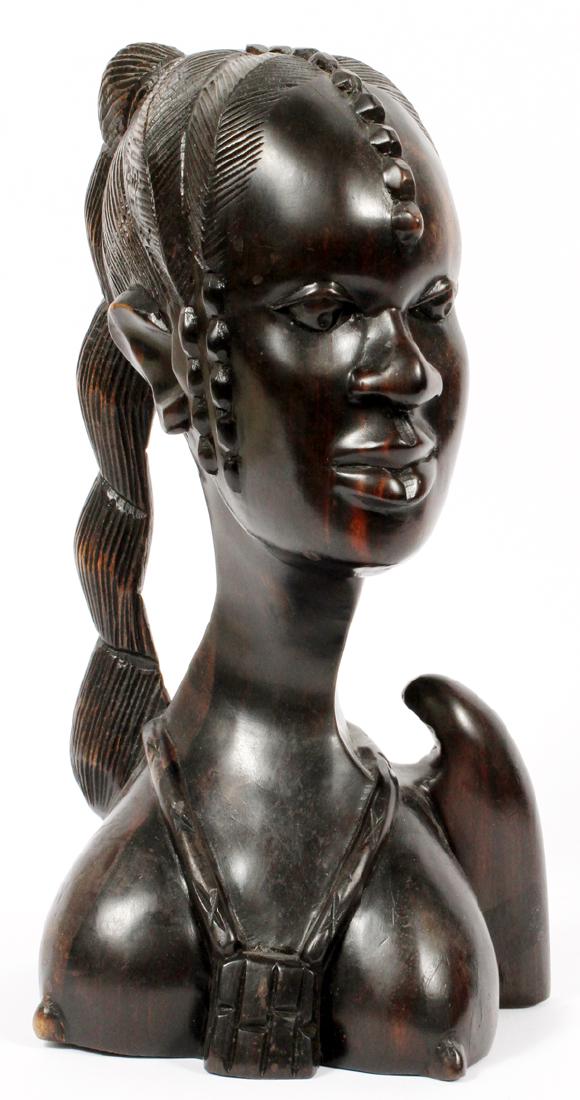 B. EGLE CARVED EBONY BUST: B. EGLE (20TH C.) CARVED EBONY BUST, H 12", W 6 1/2", D 7 1/4"CARVED BUST OF AN WOMAN WITH ELABORATELY STYLED COIFFURE AND SCARIFICATION TO CHEEKS AND FOREHEAD; SIGNED AT THE UNDERSIDE. HAVING A REDDI