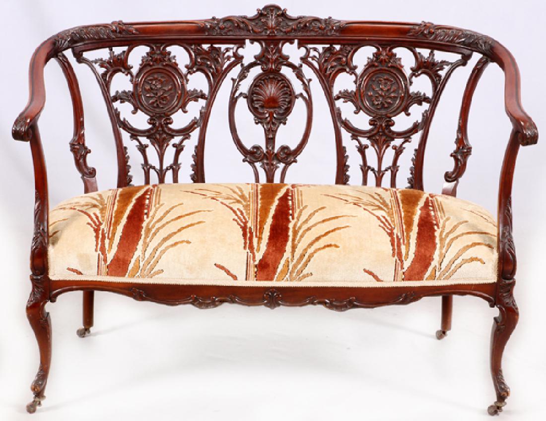 GEORGE III STYLE MAHOGANY SETTEE: GEORGE III STYLE MAHOGANY SETTEE, H 35", L 47", D 24":A George III style settee with upholstered seating and a scrolling leaf back splat, standing on casters.