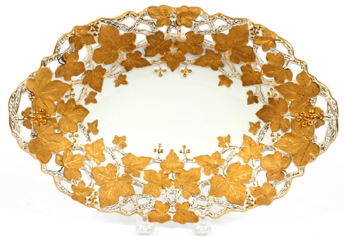 MEISSEN PORCELAIN GILT OVAL DISH, W 8 1/2", L 13": MEISSEN PORCELAIN GILT OVAL DISH, W 8 1/2", L 13":Having a white ground, gilt grape and leaf design with blue unglaze cross swords mark.