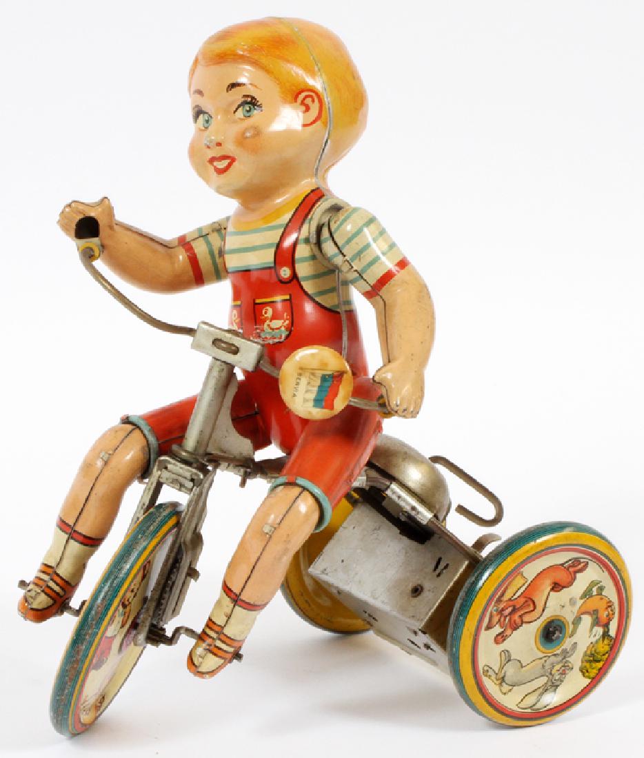 UNIQUE ART WIND-UP TIN TOY CIRCA 1950: UNIQUE ART, WIND-UP TIN TOY, CIRCA 1950, H 8.5", L 8", "KIDDY CYCLIST" :A wind-up tin toy, by Unique Art Mfg. Co, Inc., titled "Kiddy Cyclist".