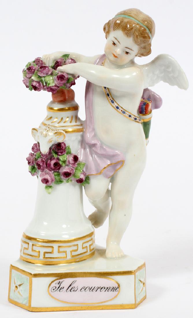 MEISSEN PORCELAIN FIGURE OF CUPID H 5 1/2": MEISSEN PORCELAIN FIGURE OF CUPID H 5 1/2" :Underglaze blue crossed swords mark. "Je Les Couronne". White ground with pink and rose flowers. Cupid as coquette modeled by Heinrich Schwabe.
