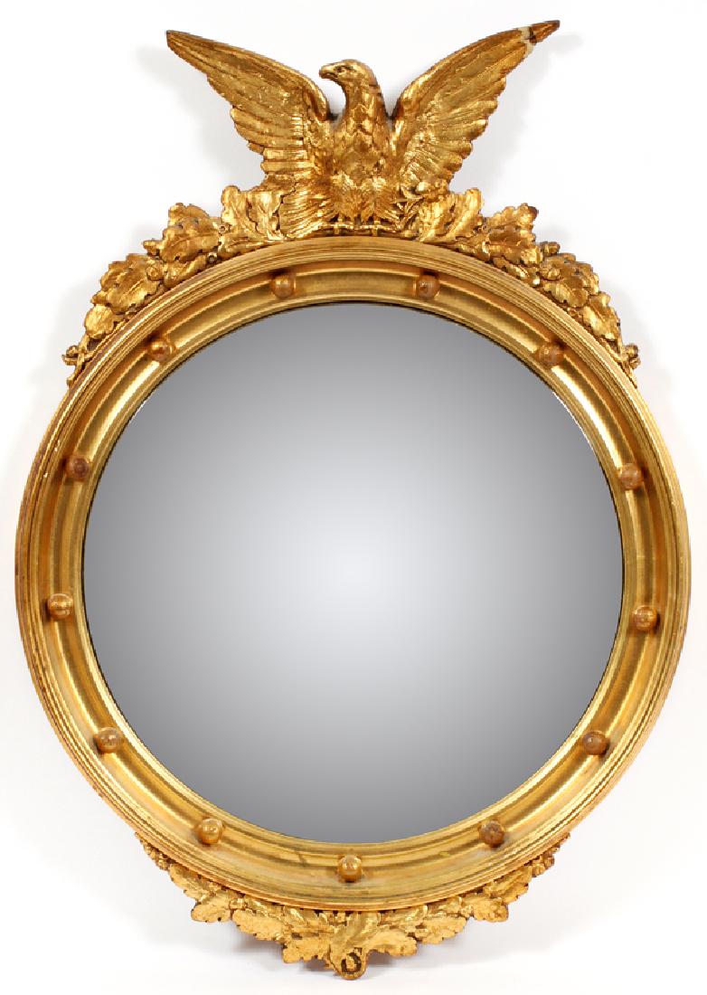 CARVED WOOD GILT EAGLE CRESTED BULLS EYE MIRROR: CARVED WOOD GILT EAGLE CRESTED BULLS EYE MIRROR, H 30", DIA 22" :Having an eagle crest with leaf accents and a thirteen ball border.
