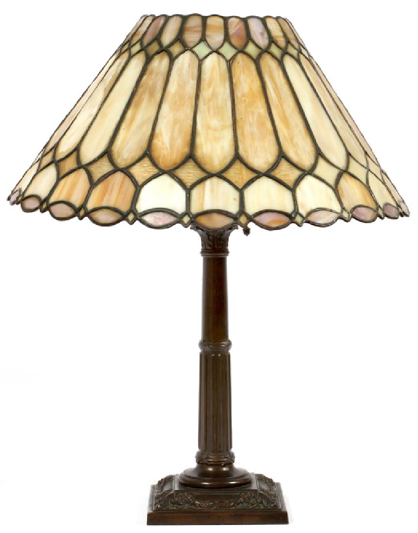 LEADED GLASS, BRONZE BASE TABLE LAMP, CIRCA 1920: LEADED GLASS, BRONZE BASE TABLE LAMP, CIRCA 1920 H 24 1/2",` DIA 18 1/2" :A leaded glass lamp, having a circular shape shade with caramel glass and a cast metal base. Good detail to bronze base. One s