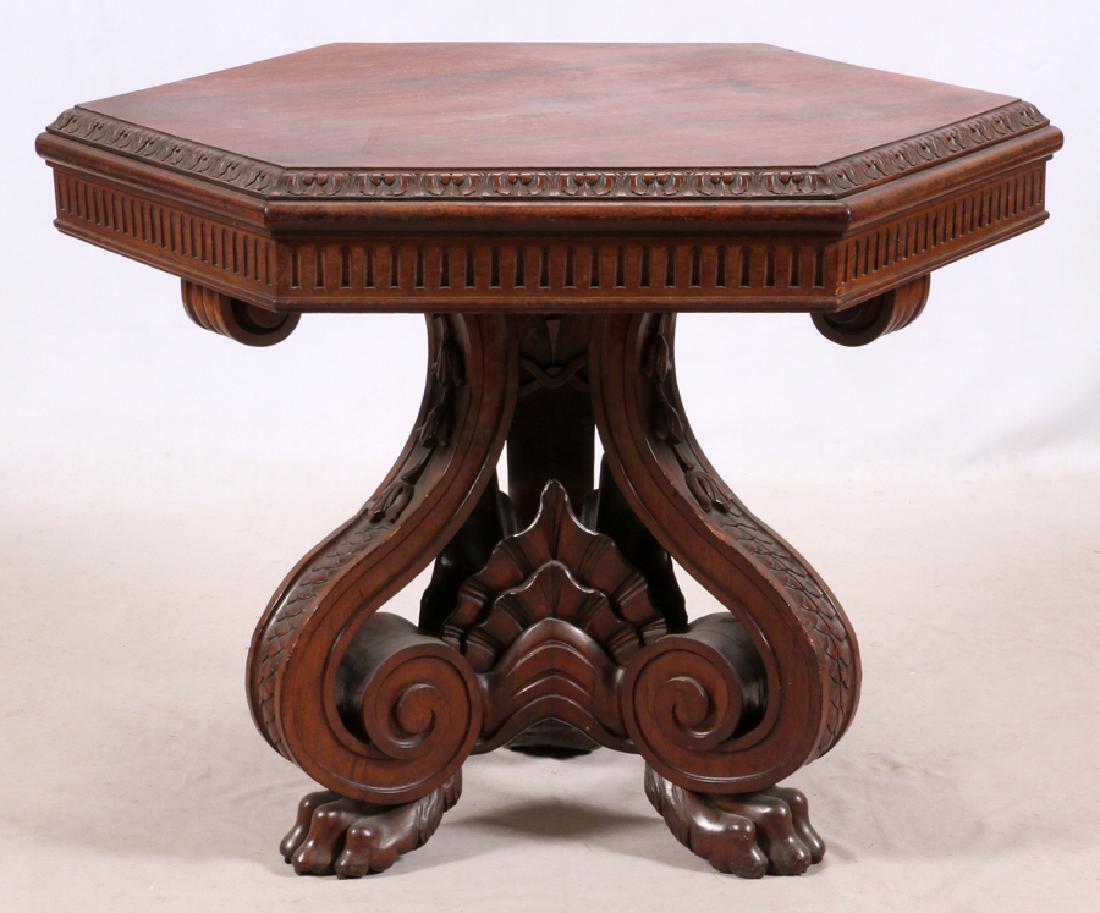 ITALIAN ANTIQUE CARVED WALNUT CENTER TABLE: ITALIAN ANTIQUE CARVED WALNUT CENTER TABLE, H 30 1/4'', DIA 44'' Hexagonal. Paw feet, serpent skin decoration along legs with flower accents at the top of the legs.