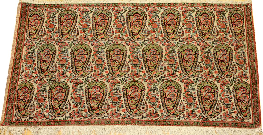 PERSIAN ANTIQUE SENNA HAND WOVEN WOOL MAT: PERSIAN ANTIQUE SENNA HAND WOVEN WOOL MAT, W 1' 9", L 3' 3 1/2" :A Botek (paisley) design set into an ivory ground, with a repetitious pattern of leaves with a green border and multi-colored interior