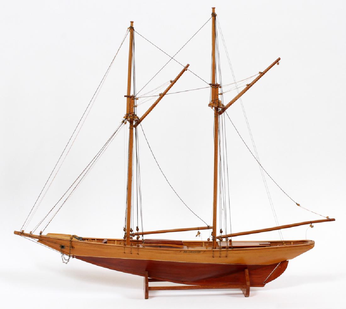 WOOD SCHOONER MODEL, CIRCA 1950 "BLUENOSE": WOOD SCHOONER MODEL, CIRCA 1950, H 28'', L 30'', "BLUENOSE" :Cod fishing, gaff rigged schooner 'Bluenose', with rigging. By E. Le Clerc Family. Gaspe, Peninsula. Mounted on a cradle.