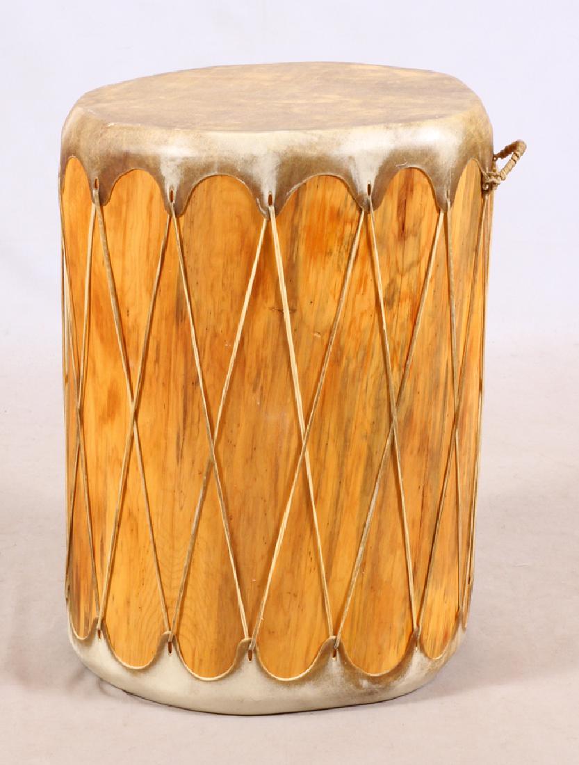 NATIVE AMERICAN 'TAOS' TREE TRUNK & RAWHIDE DRUM: NATIVE AMERICAN 'TAOS' TRIBE, PREMIER SIZE, CARVED TREE TRUNK AND RAWHIDE DRUM, C1900, H 30", DIA 22" :Carved tree trunk with rawhide skins. From the Native American 'Taos' tribe. Per the consignor, s