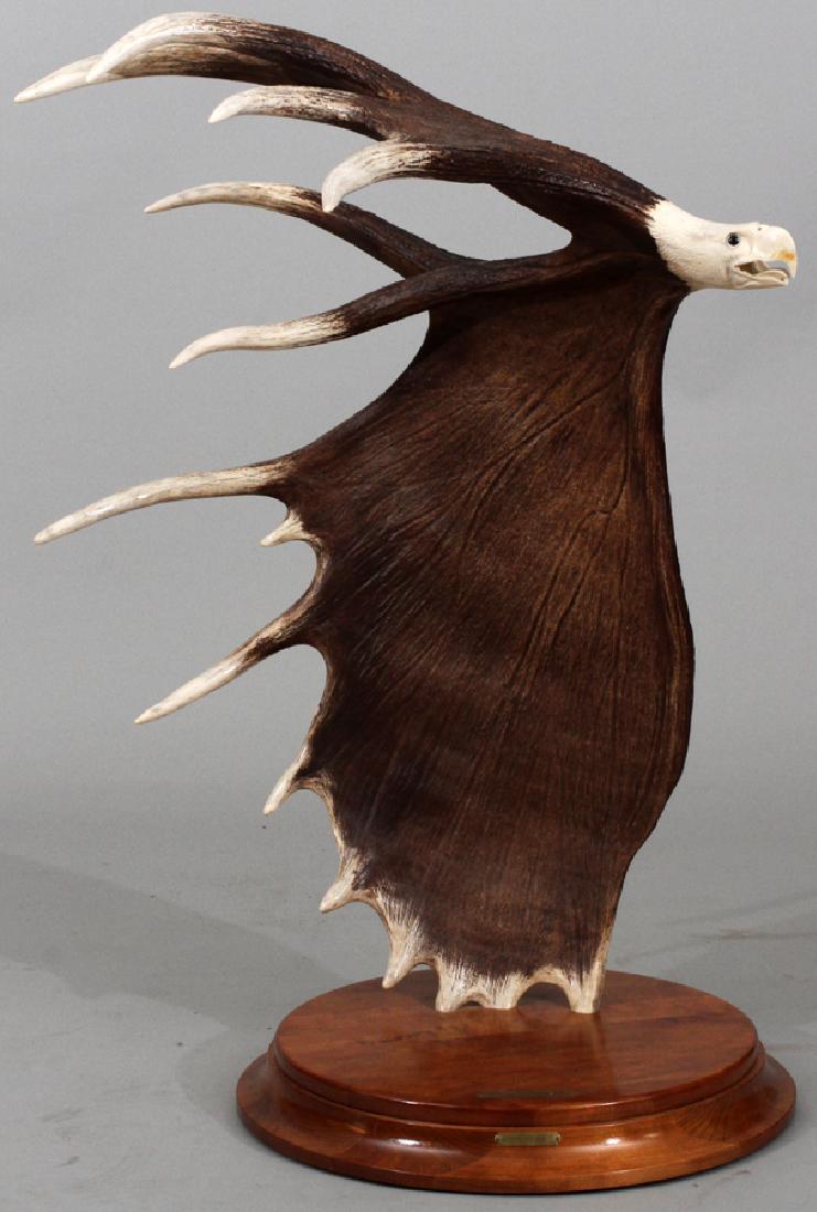 DAWN STONE, CARVED MOOSE ANTLER, "EAGLE FLIGHT": DAWN STONE, CARVED MOOSE ANTLER, "EAGLE FLIGHT", H 33", L 25" :Carved moose antler with the base of the antler carved into an eagles head with the antlers representing the wings and entitled: "Eagle F