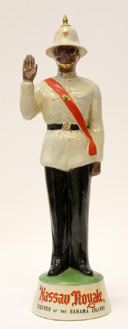 HARPER FIGURAL PORCELAIN LIQUEUR DECANTER: HARPER FIGURAL, PORCELAIN LIQUEUR DECANTER, H 19", W 5", D 5", NASSAU POLICEMAN :Depicts a Nassau Policemen standing on an integral base inscribed "Nassau Royale Liqueur Of The Bahamas". Bottle made i