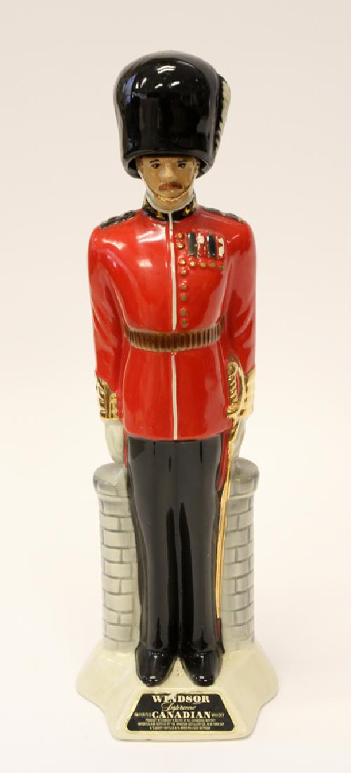 WINDSOR PORCELAIN WHISKY DECANTER: WINDSOR, PORCELAIN WHISKY DECANTER, H 17", W 5", D 4 1/2 :Hand decorated porcelain whisky decanter in the form of a Windsor Guard. mounted on an integral base inscribed: "Windsor Supreme Imported Cana