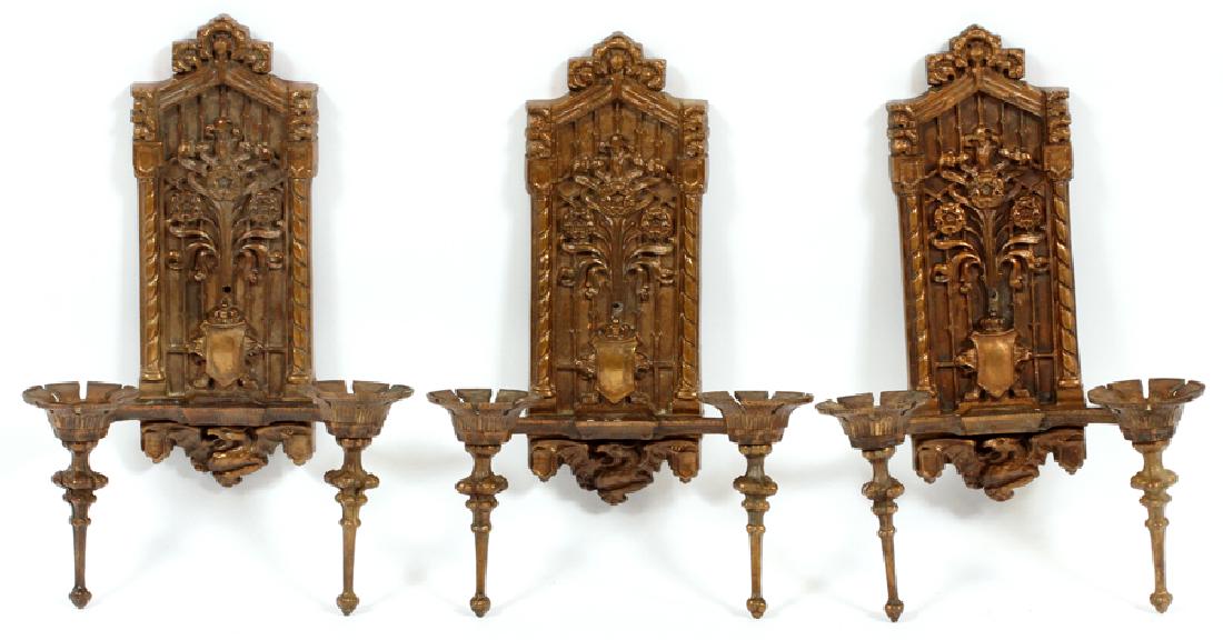 CAST IRON WALL SCONCES C1920, SET OF THREE: CAST IRON WALL SCONCES C1920, SET OF THREE, H 14", W 9" :Central cathedral shape motif, columnar sides, floral and shield pattern with a griffin design at the base.