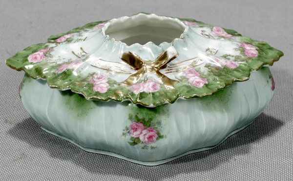 R.S. PRUSSIA PORCELAIN HAIR RECEIVER, C.1890: R.S. PRUSSIA PORCELAIN HAIR RECEIVER, C. 1890, H 2", W 5 1/2", L 6":Pink rose decoration with bow accent at the cover.