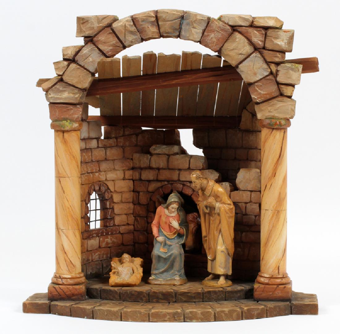 ANRI KARL KUOLT CARVED WOOD CHRISTMAS CRECHE: ANRI KARL KUOLT (ITALY 1878-1937), CARVED WOOD CHRISTMAS CRECHE, FOUR PIECES The carved nativity scene depicts a stable with animals looking in a window and figures of Joseph, Mary and Christ child in