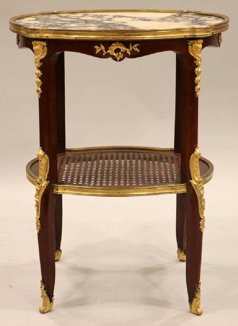 LOUIS XV STYLE MAHOGANY & MARBLE OCCASIONAL TABLE: LOUIS XV STYLE, MAHOGANY & MARBLE OCCASIONAL TABLE, H 23", L 18", DIA 16" Having an oval white and black veined top surrounded by a gilt wood edge. Ormolu trim about the contoured skirt and the legs. 