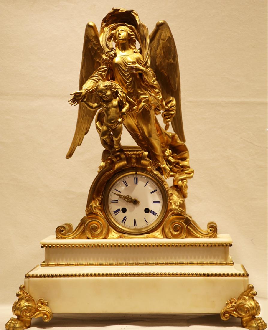 FRENCH MARBLE AND D'ORE BRONZE MANTLE CLOCK: FRENCH VINCENTI & CIE MEDAILLE D'ARGENT MARBLE AND D'ORE BRONZE MANTLE CLOCK, H 19.5", L 15", D 6.5":Featuring a winged female figure and a cherub. White face with Roman numerals, two key wind. All mo