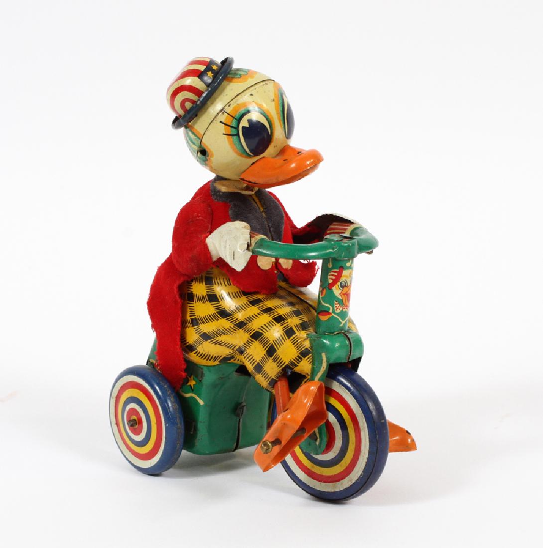 HADSON JAPANESE TIN WIND-UP TOY: HADSON JAPANESE TIN WIND-UP TOY, H 6", DUCK PEDALING A BICYCLE A Hadson Japanese tin wind-up toy depicting a duck peddling a bicycle.
