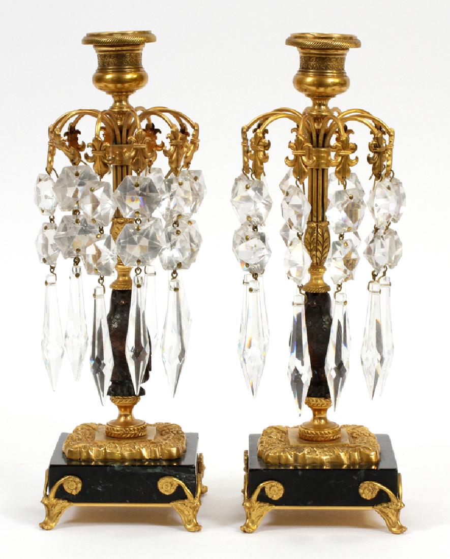 CRYSTAL CHANDELIER MANTLE LUSTERS, CA. 1850, PAIR: CRYSTAL CHANDELIER MANTLE LUSTERS, CA. 1850, PAIR, H 10 1/4", W 3 1/2"A pair of crystal chandelier candlestick mantle lusters. These pieces feature gilt metal frame and an eagle motif bodice situated