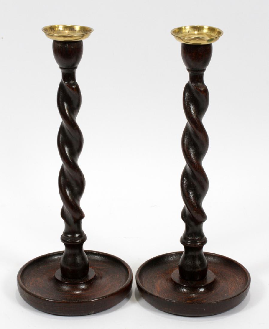 ENGLISH ANTIQUE CARVED OAK AND BRASS CANDLESTICKS: ENGLISH, ANTIQUE, CARVED OAK AND BRASS, CANDLESTICKS, C19TH C, 2 PCS., H 12" :Two antique English oak candlesticks. Having carved spiral designs, with brass cups.