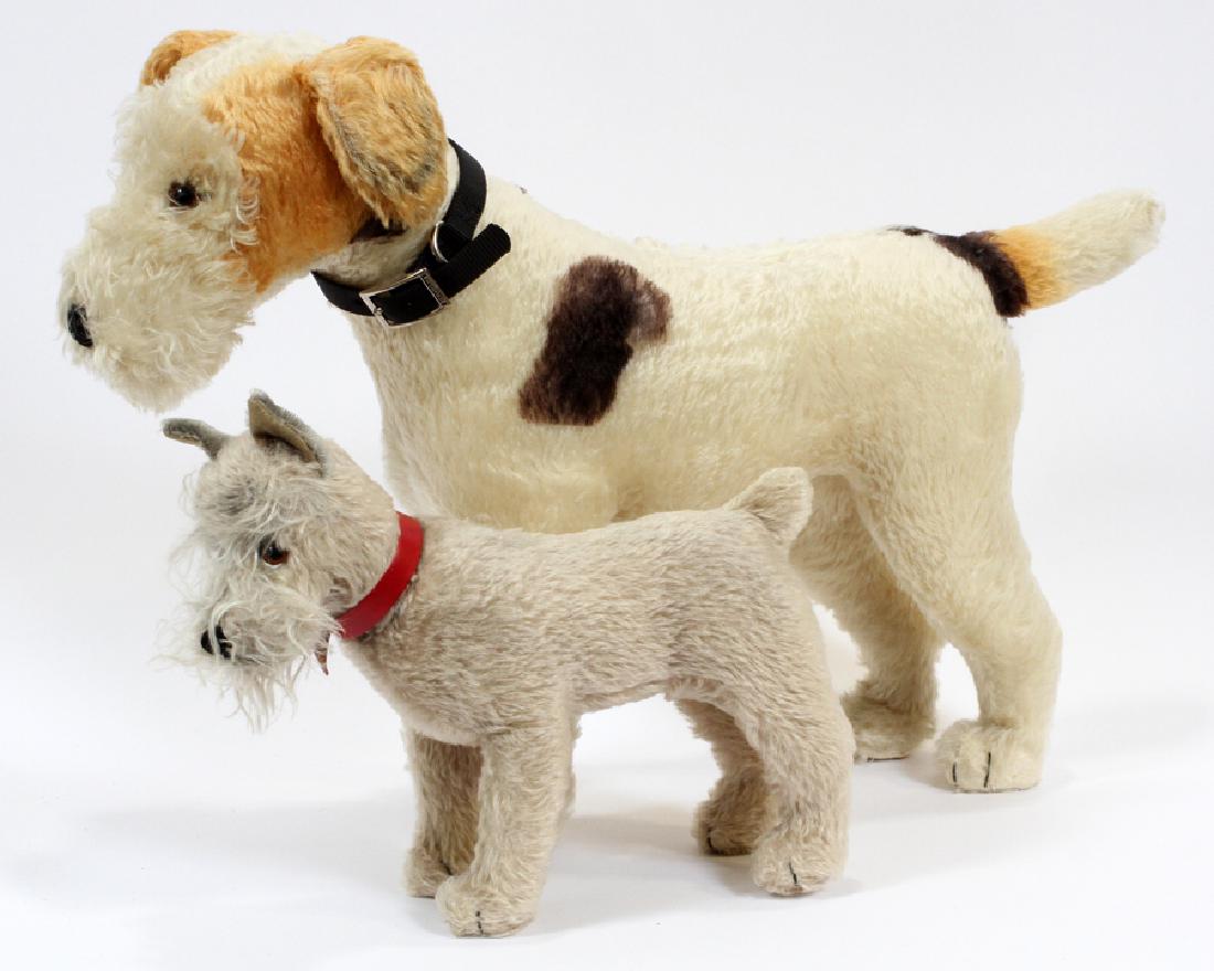 STEIFF PLUSH TERRIERS, 2 PCS, H 17 1/2", L 25": STEIFF PLUSH TERRIERS, 2 PCS, H 17 1/2", L 25":A pair of vintage Steiff plush terrier dogs. The larger includes a pull string sound box to the back of its neck. The smaller measures 10 3/4" H, 14" L.