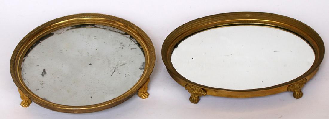FRENCH, BRONZE PLATEAU, MIRRORED DRESSING TRAYS: FRENCH, BRONZE PLATEAU, MIRRORED DRESSING TRAYS, CA. 1850, PAIR, W 9 1/4", L 12":A pairing of Surtout French gilded bronze and silver mirror dressing trays, c1850s. These pieces feature low relief emb