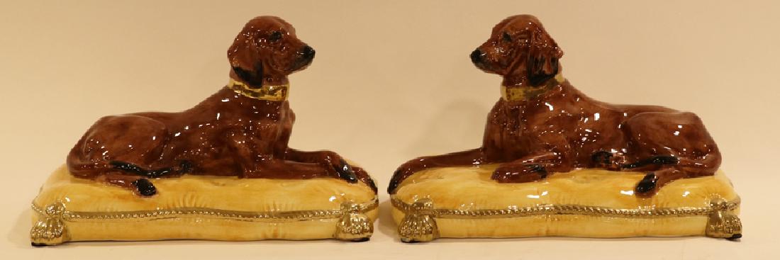 PORCELAIN BLOODHOUNDS ON YELLOW PILLOWS, 2 PCS.: PORCELAIN BLOODHOUNDS ON YELLOW PILLOWS, 2 PCS., H 7", W 12", D 7" :two porcelain reclining bloodhounds on yellow pillows.