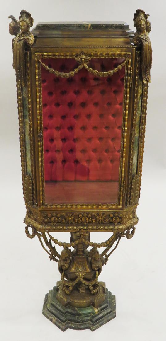 FRENCH BRONZE & MARBLE VITRINE, 19TH C.: FRENCH BRONZE & MARBLE VITRINE, 19TH C., H 52 1/2", W 21", D 11":A 19th century French gilded bronze and green marble display casket or vitrine. Having a latched, hinged door and a tufted silk backboa