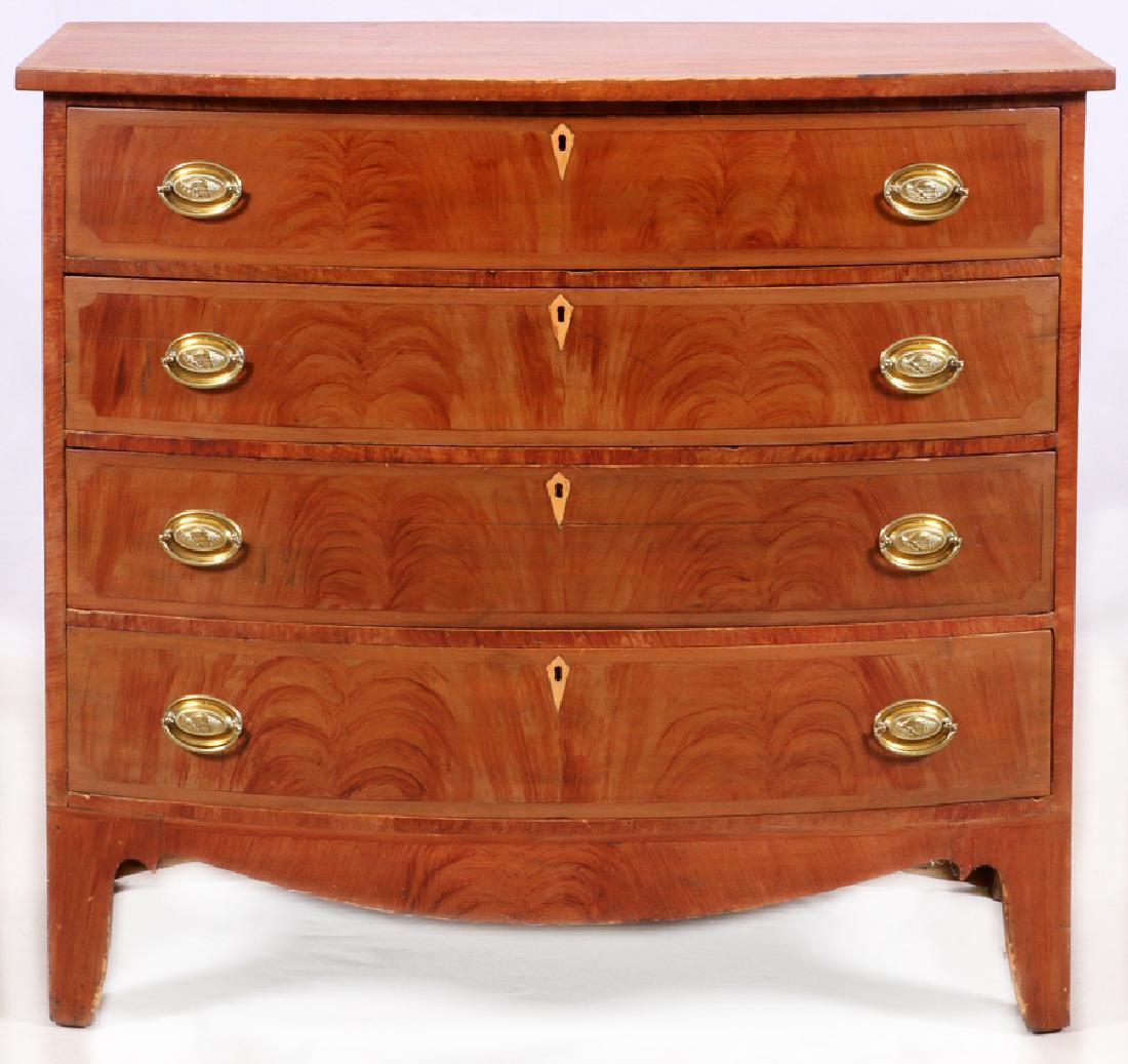 NEW ENGLAND GRAIN PAINTED BOWFRONT CHEST: NEW ENGLAND GRAIN PAINTED BOWFRONT CHEST, 1790 - 1810, H 39", W 42", D 22" :With wood inlay key escutcheons, a bow front chest with drop handles and a swooping lower apron. From the Estate of Margaret