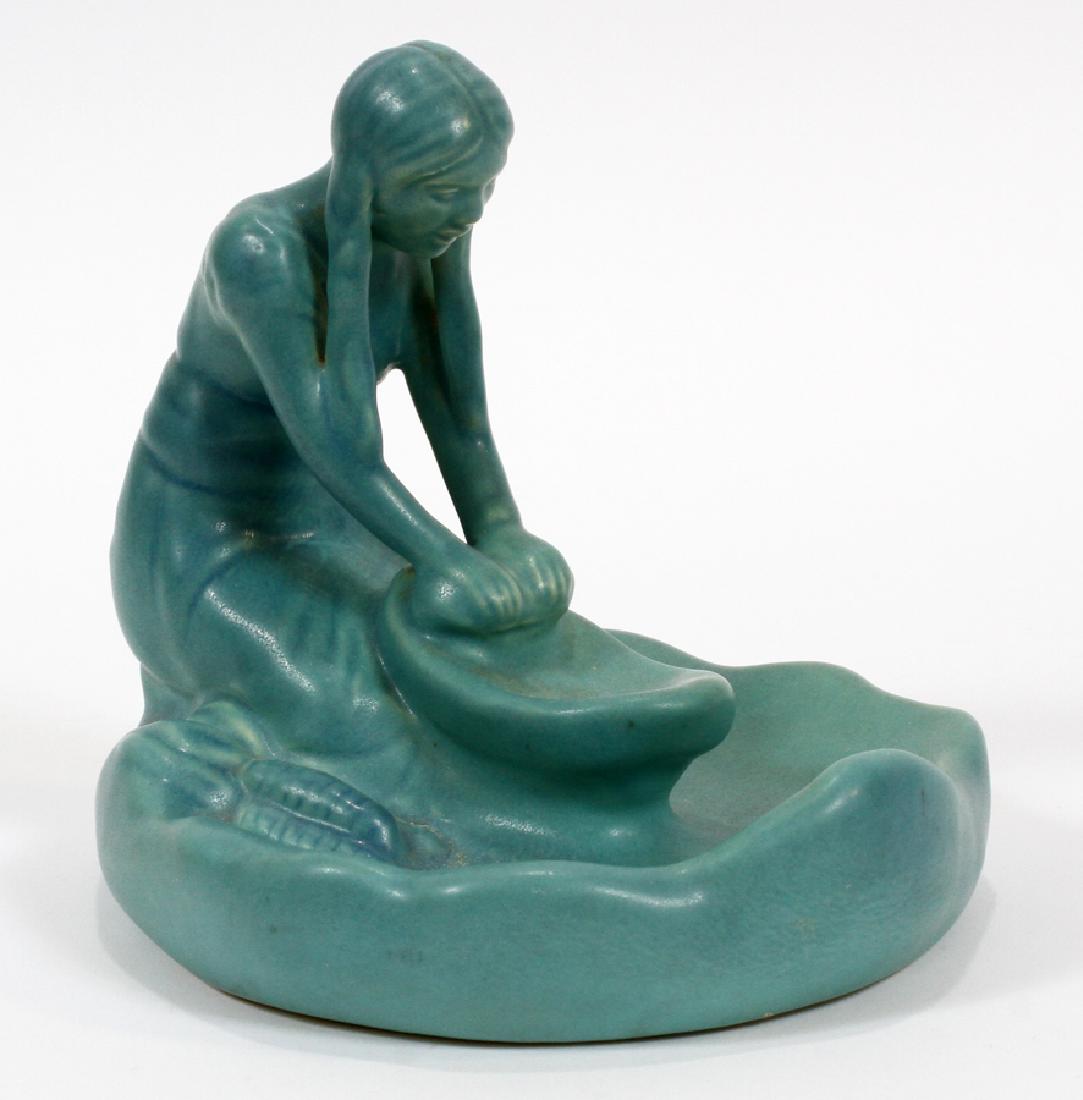 VAN BRIGGLE ART POTTERY FIGURINE GRINDING CORN: VAN BRIGGLE ART POTTERY FIGURINE, H 5 1/2", DIA 7", GRINDING CORN :A Van Briggle Pottery figurine. This piece features a stylized azure blue Native American maiden grinding corn. Signature branding et