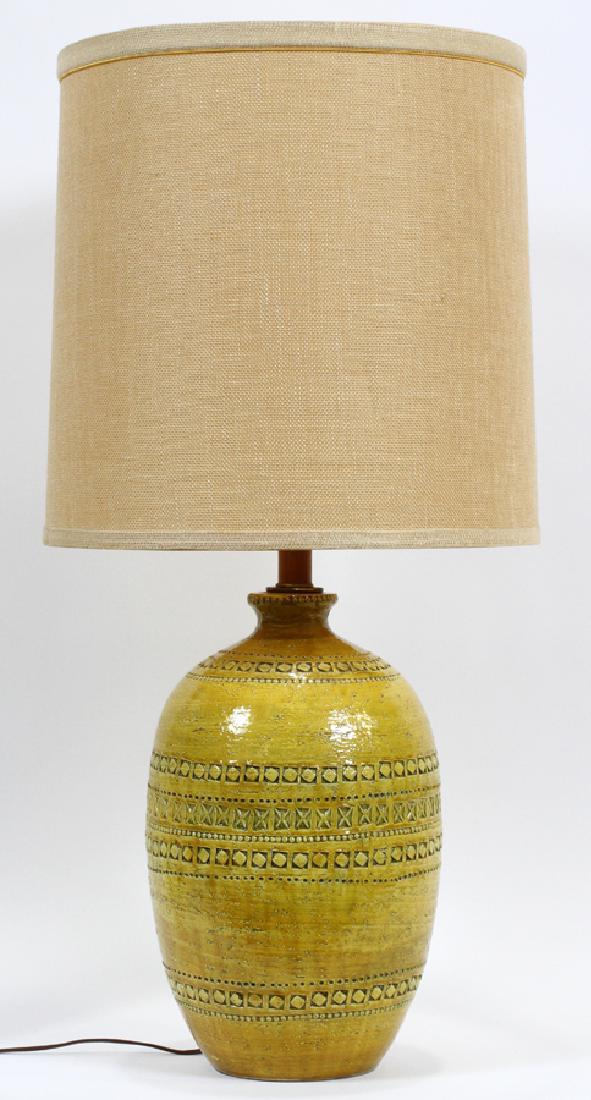 CERAMIC LAMP, VINTAGE, H 33 1/2", DIA 15": CERAMIC LAMP, VINTAGE, H 33 1/2", DIA 15":An electric ceramic lamp. This lamp features a ceramic bodice featuring a yellow glass and primitive, geometric patterns etched into the stoneware.