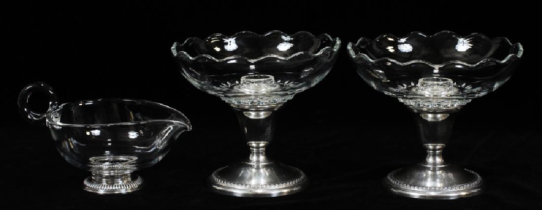 ROGERS BROS CRYSTAL AND STERLING CANDLE HOLDERS: ROGERS BROS CRYSTAL AND STERLING CANDLE HOLDERS (2) ALSO PITCHER :Sterling weighted bases, crystal inserts by Rogers Bros. Height 4.5". Also sauce pitcher with sterling rim H 2.5". Three articles.