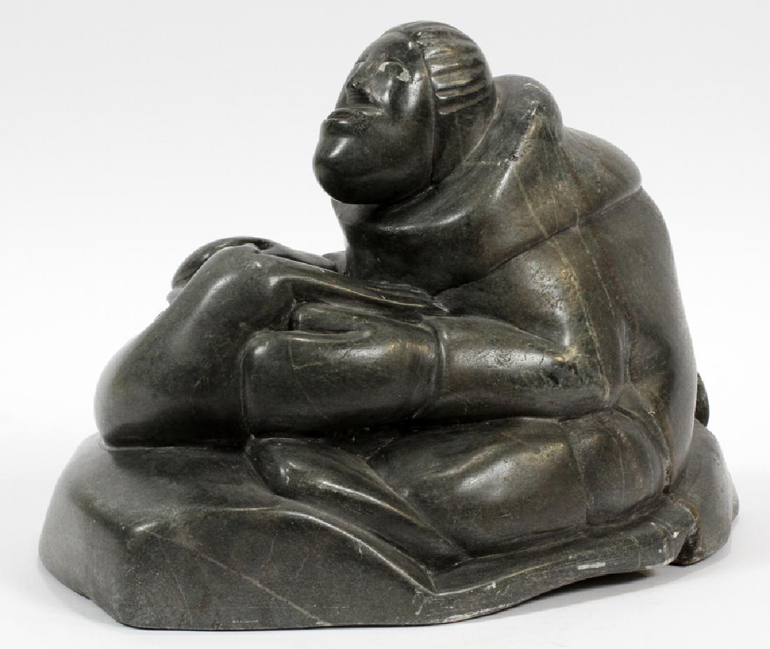 INUIT SOAPSTONE CARVING: INUIT SOAPSTONE CARVING, H 9 3/4", W 14", D 9", SEAL HUNTER :An Inuit soapstone carving. This piece depicts a seal hunter. Numerical marks and possible artist's signature etched to the underside.