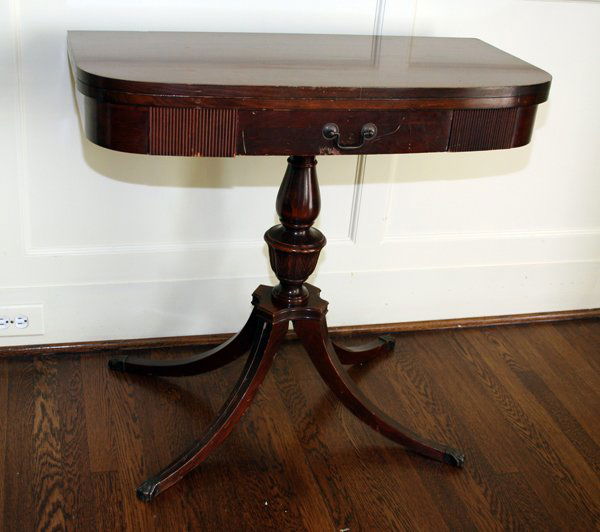 MAHOGANY FLIP-TOP TABLES, MID 20TH C., PAIR: MAHOGANY FLIP-TOP TABLE, MID 20 TH C, PAIR, H 30", W 32", L 36" OVERALL:both having Duncan Phyfe style with pedestal bases, four legs and central carved urn shaft; with tops unopened, 16" W;