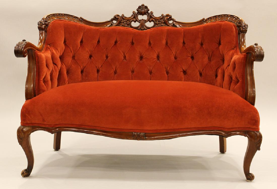 VICTORIAN HAND-CARVED MAHOGANY SETTEE: VICTORIAN HAND-CARVED MAHOGANY SETTEE H 35" L 48" D 26" :Having a mahogany frame with pierced design backrest crest, contoured armrests cabriole legs. Rust color velvet seat cushion and tufted upholst