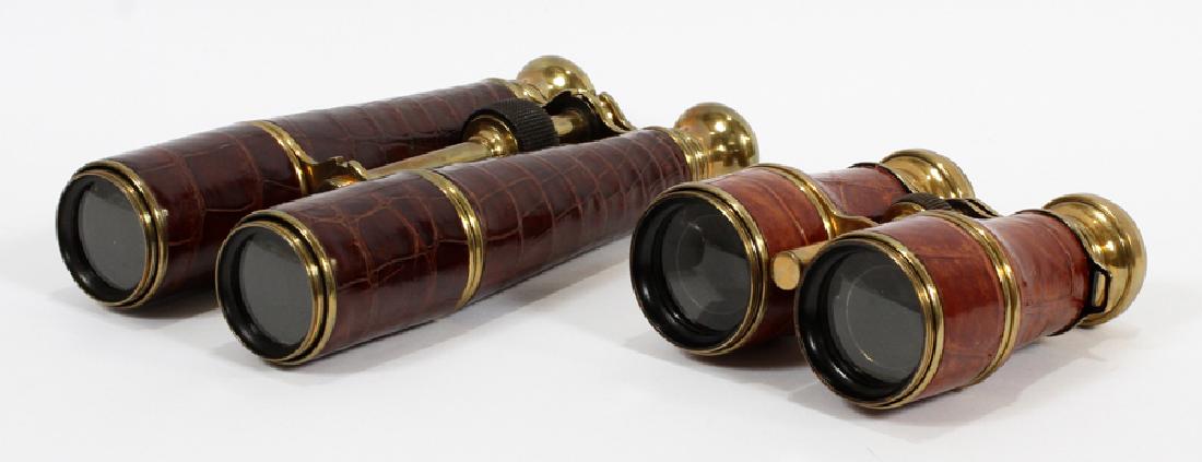 ANTIQUE BINOCULARS, 2 PCS, H 8", L 4.5": ANTIQUE BINOCULARS, 2 PCS, H 8", L 4.5":A pairing of two antique binoculars. Each piece having leather overlays and brass hardware. The smaller pair are French hunting binoculars manufactured by Manuf