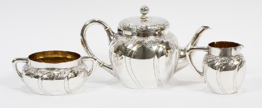 BERNHARD FRIEDLANDER SILVER TEAPOT, BOWL &CREAMER: BERNHARD FRIEDLANDER DUSSELDORF, GERMANY 800 SILVER TEAPOT, SUGAR BOWL AND CREAMER :The teapot has a hinged lid with spherical finial with an ivory insulator (as is). Swirl designs to the sides of eac