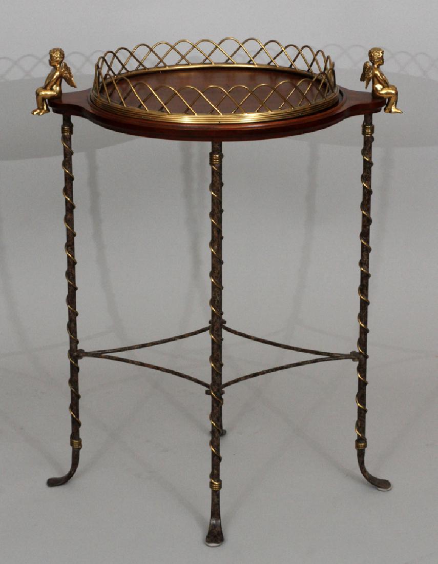 MAITLAND SMITH MAHOGANY AND BRASS TRAY TABLE: MAITLAND SMITH MAHOGANY AND BRASS TRAY TABLE H 29" W 23" D 14" :Maitland Smith mahogany and brass tray table. Having wire wrapped metal legs terminating in snake form feet, with two winged gilded cher